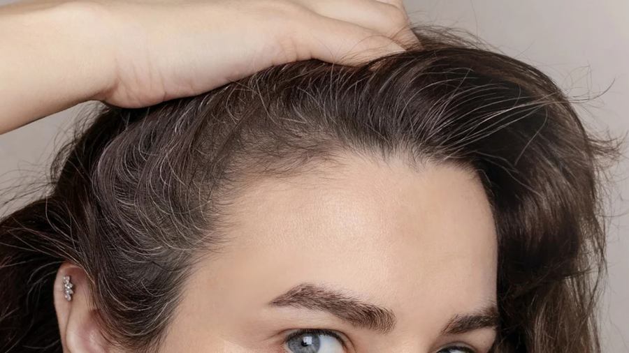 Fingertips on a calm scalp, close up